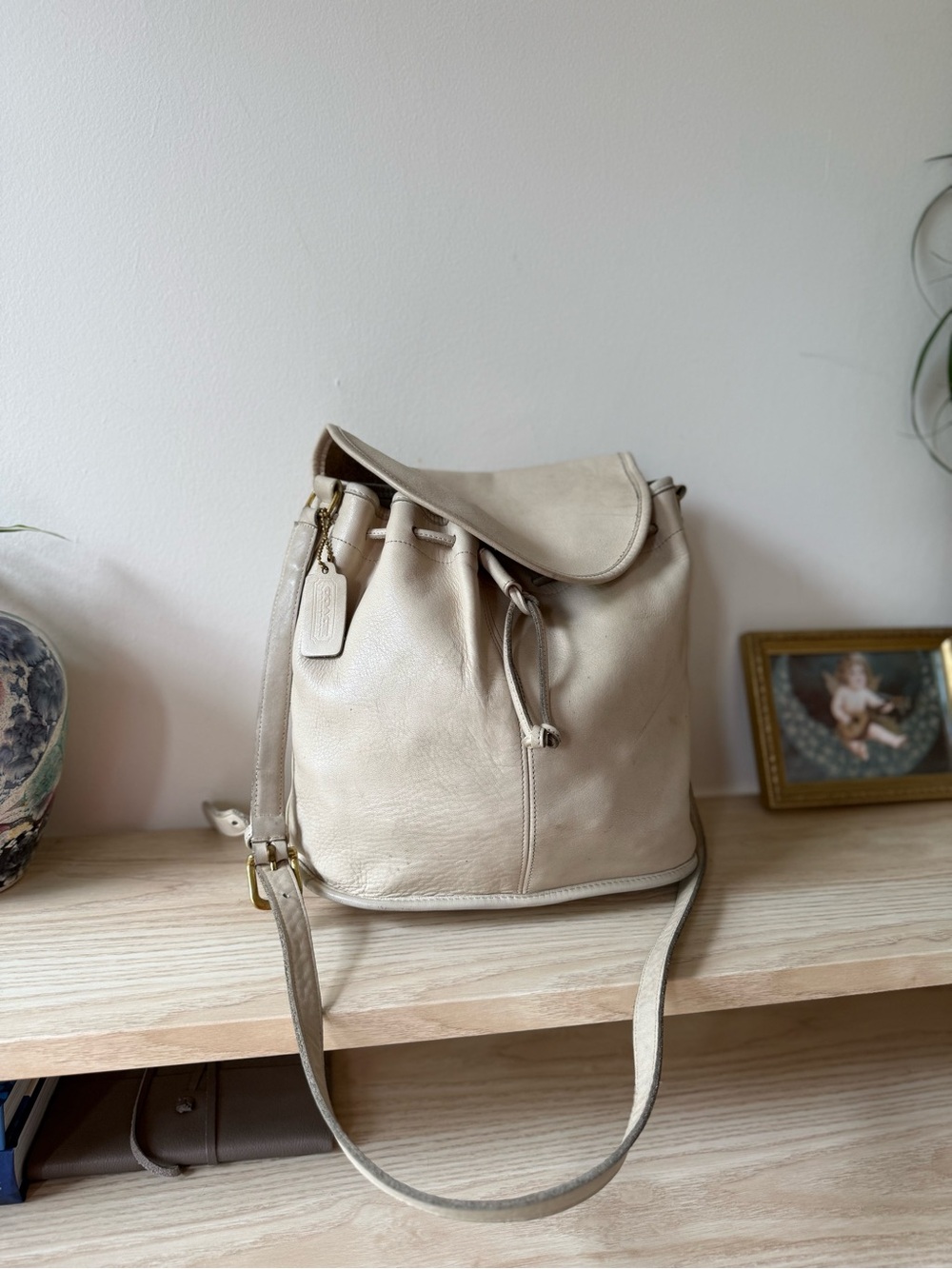 1980s Coach NYC Cream Leather Bucket Bag with Drawstring and flap top